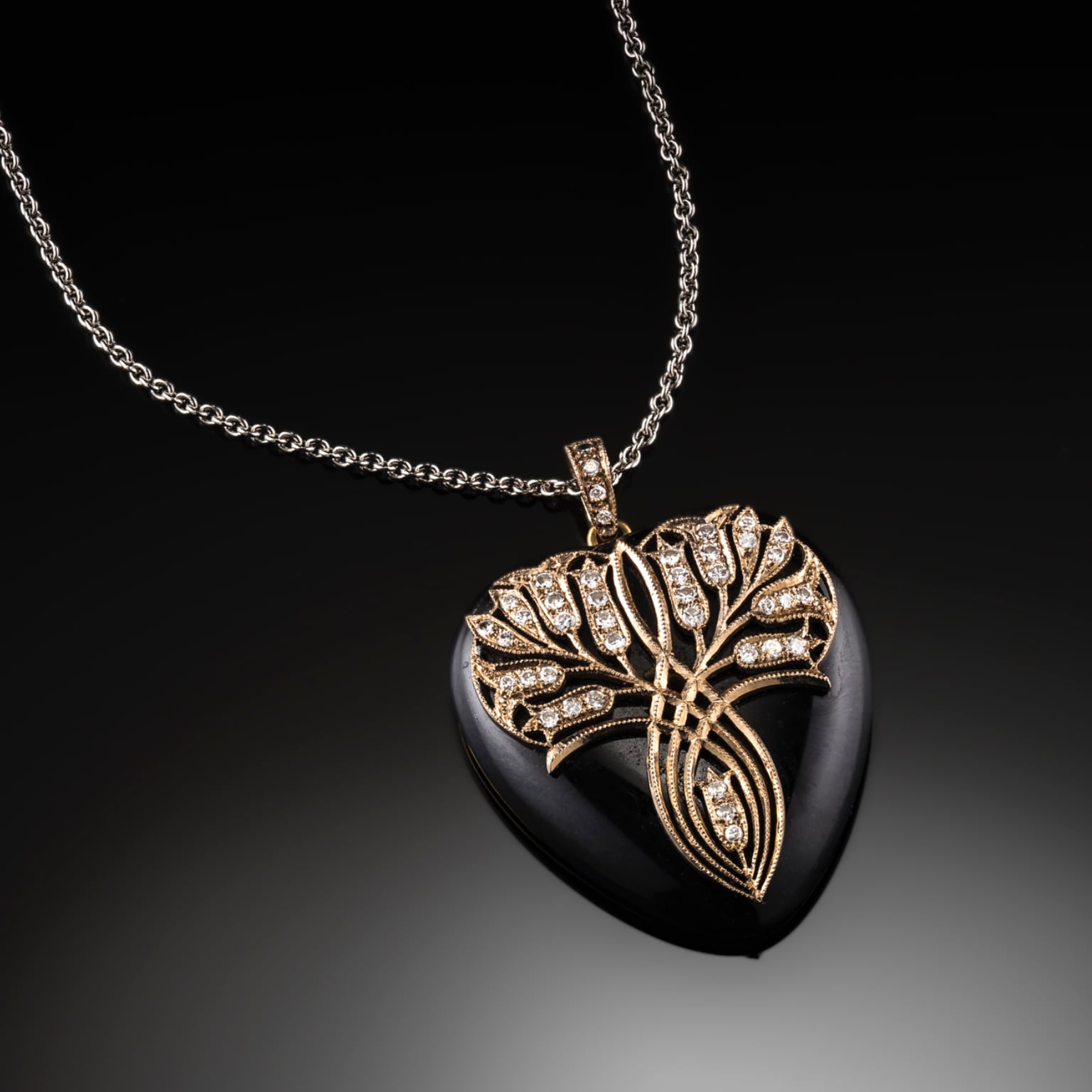 LATE 1930S ART DECO ONYX 18CT GOLD AND DIAMOND HEART PENDANT