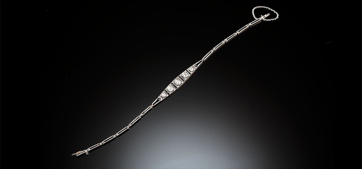 A delicate Art Deco overlaid platinum on gold diamond onyx flexible link bracelet