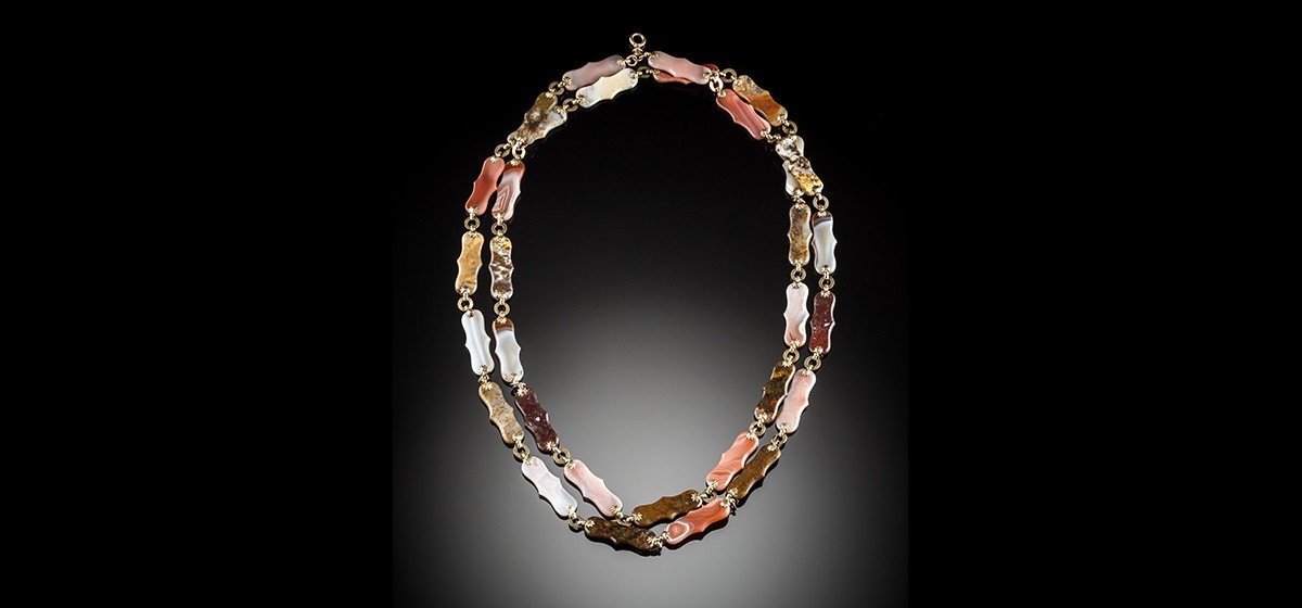 An antique long chain of flat polished multi coloured hardstones panels