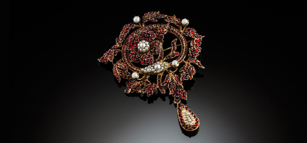 A large Antique garnet and pearl brooch