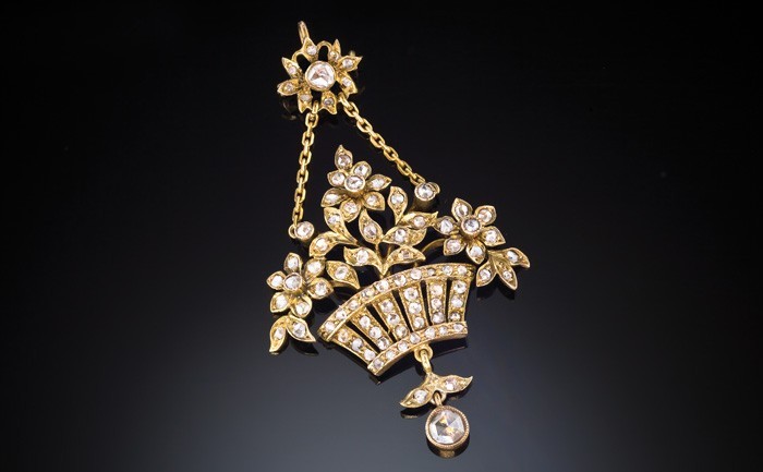 Detail of an Antique yellow gold and diamond set flower basket pendant/brooch