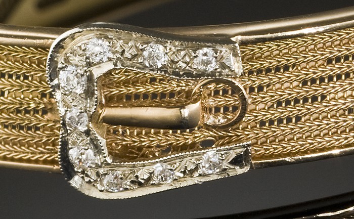 An antique diamond and yellow gold hinged buckle design bangle