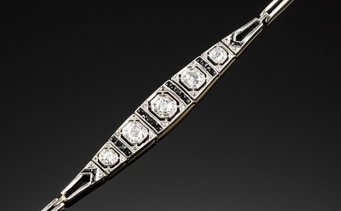 A delicate Art Deco overlaid platinum on gold diamond onyx flexible link bracelet