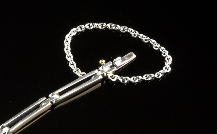 A delicate Art Deco overlaid platinum on gold diamond onyx flexible link bracelet