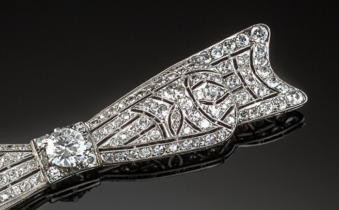 An Art Deco handcrafted platinum and diamond elongated bow brooch 